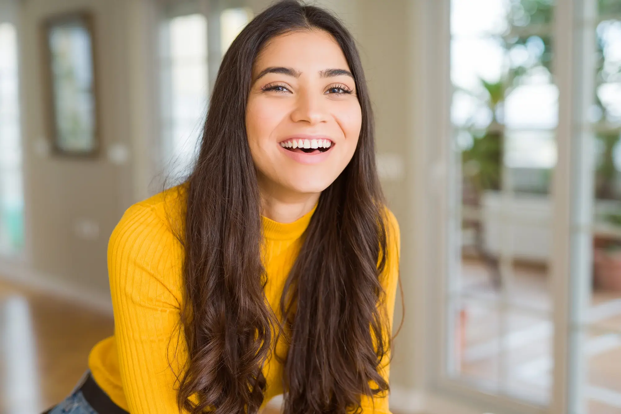 Woman in a yellow cardigan smiling